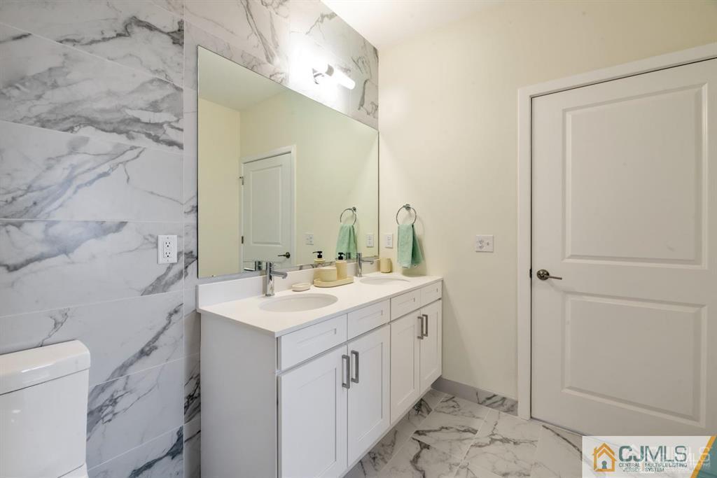 1 Nolan Way, Unit A2 North Brunswick, NJ 08902 - Photo 16 of 71 a bathroom with a sink and a mirror