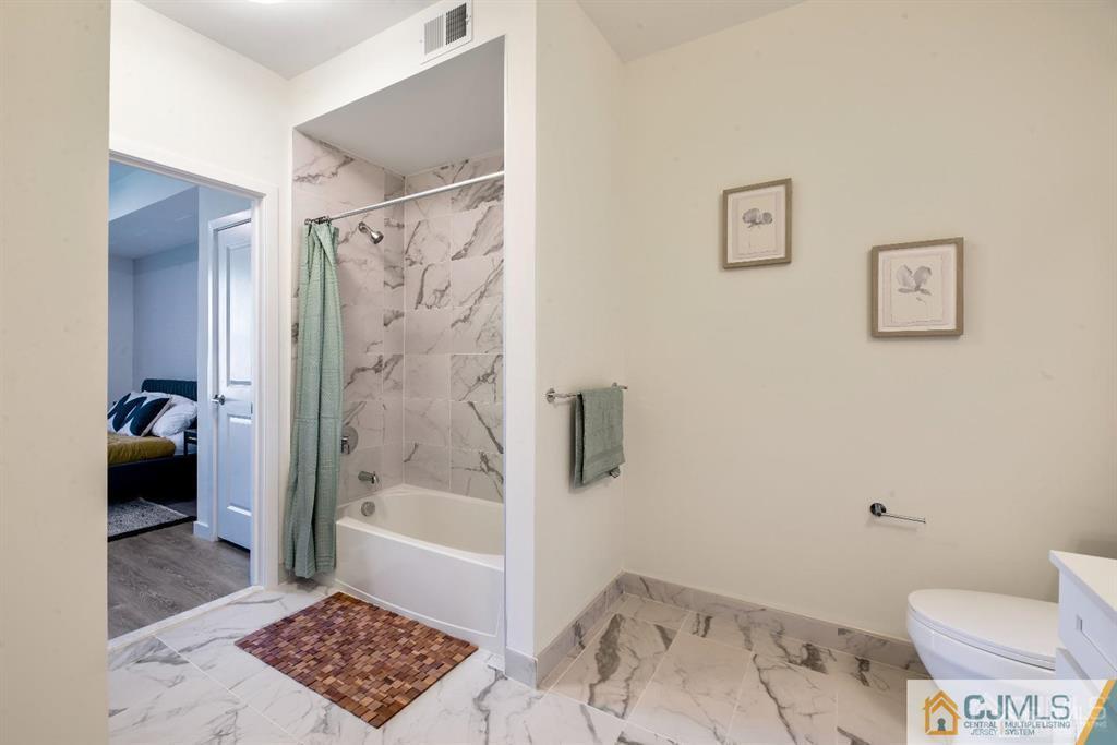 1 Nolan Way, Unit A2 North Brunswick, NJ 08902 - Photo 18 of 71 a bathroom with a toilet and a shower