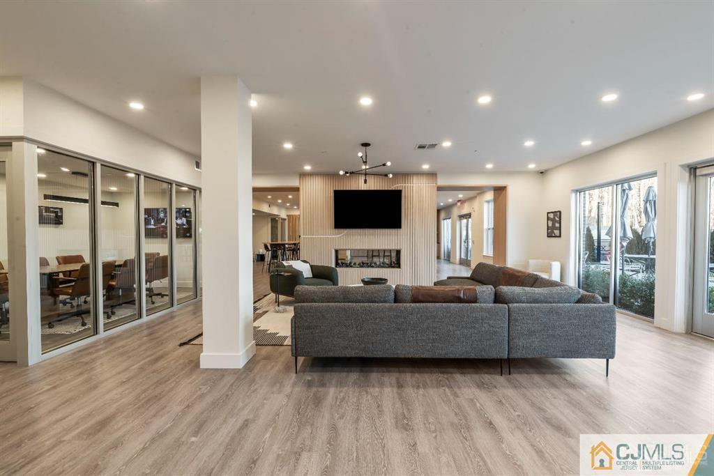 1 Nolan Way, Unit A2 North Brunswick, NJ 08902 - Photo 44 of 71 a living room with furniture and a flat screen tv