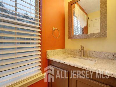31 Edinburgh Court Edison, NJ 08820 - Photo 11 of 25 a bathroom with a granite countertop sink and a mirror