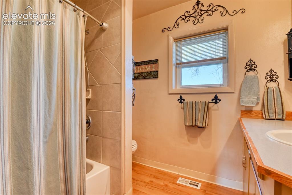 22558 Enoch Road Calhan, CO 80808 - Photo 37 of 50 a bathroom with a sink a mirror and shower