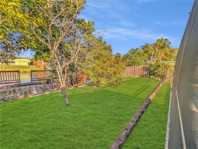 a view of a backyard with large trees