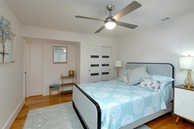 a spacious bedroom with a bed and a chandelier