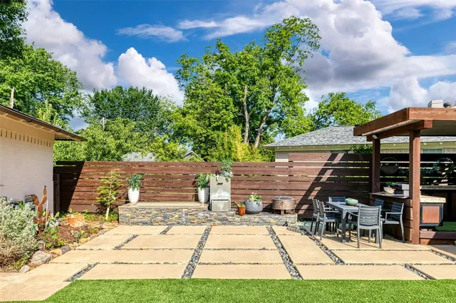 a patio with glass top table and chairs