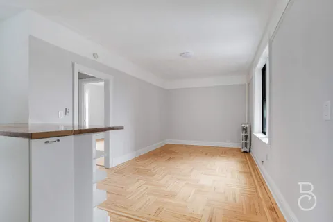 a view of a room with wooden floor and cabinet