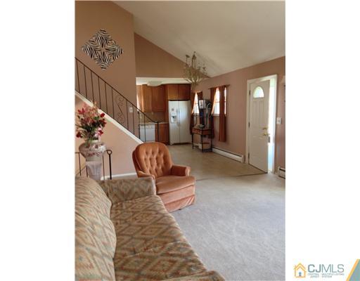 60 Eardley Road Edison, NJ 08817 - Photo 12 of 17 a hallway with beautiful frames and flower vase