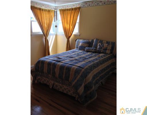 60 Eardley Road Edison, NJ 08817 - Photo 13 of 17 a bedroom with a bed and a window