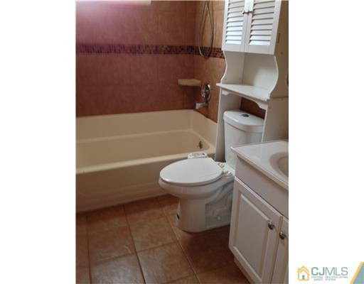 60 Eardley Road Edison, NJ 08817 - Photo 14 of 17 a bathroom with a toilet and a bathtub