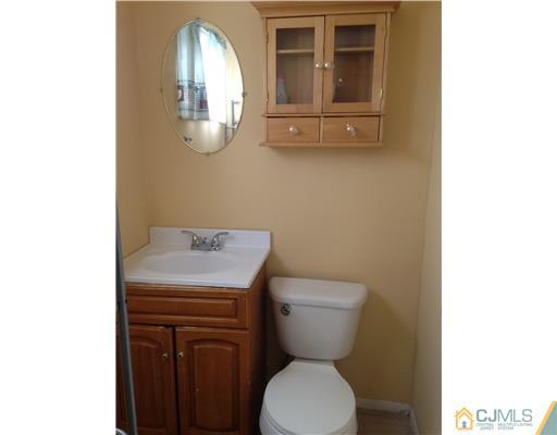 60 Eardley Road Edison, NJ 08817 - Photo 15 of 17 a bathroom with a toilet sink and mirror