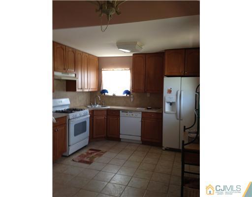 60 Eardley Road Edison, NJ 08817 - Photo 3 of 17 a kitchen with a sink stainless steel appliances and cabinets