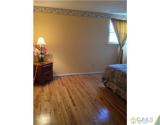 60 Eardley Road Edison, NJ 08817 - Photo 6 of 17 a bedroom with a bed and a window