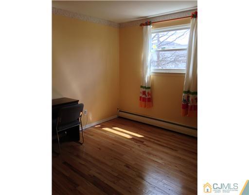 60 Eardley Road Edison, NJ 08817 - Photo 7 of 17 a view of an empty room with wooden floor and a window