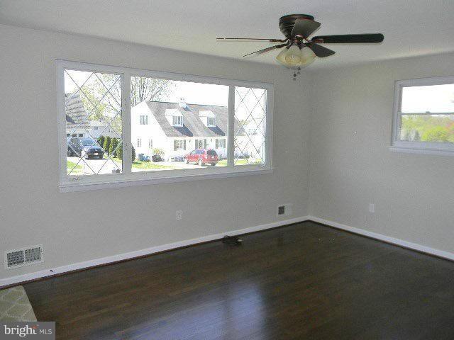 9634 Dundawan Road Baltimore, MD 21236 - Photo 7 of 18 a view of empty room with wooden floor and fan