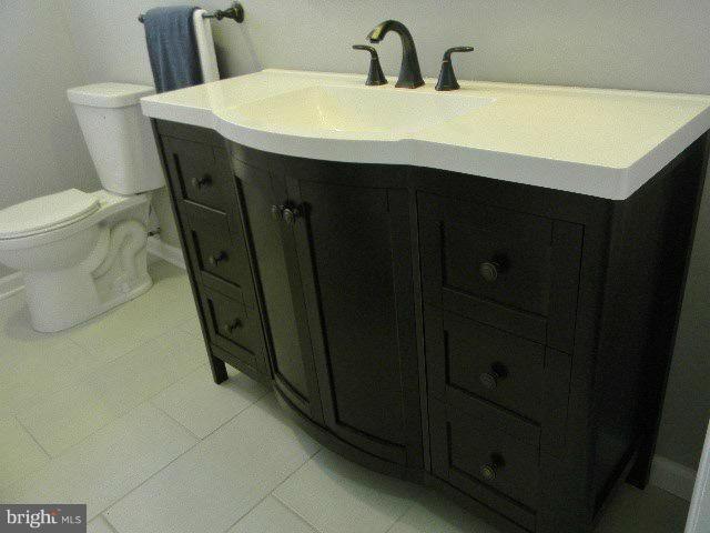 9634 Dundawan Road Baltimore, MD 21236 - Photo 9 of 18 a bathroom with a sink and a toilet