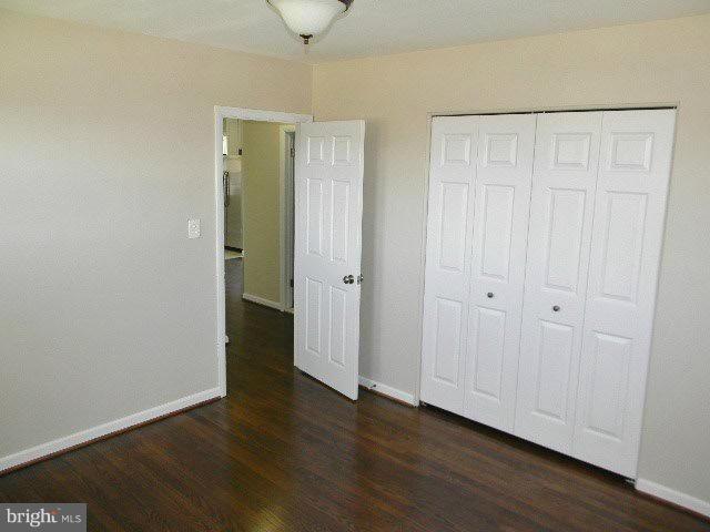 9634 Dundawan Road Baltimore, MD 21236 - Photo 10 of 18 a view of an empty room with wooden floor