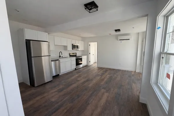a kitchen with refrigerator a stove a sink and a refrigerator