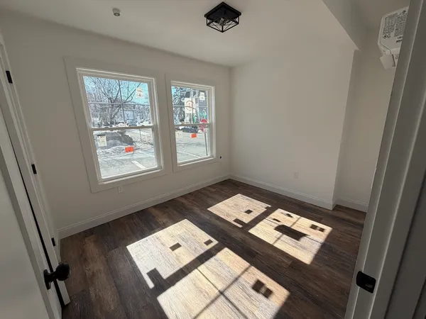 a view of a bed in a room with a window