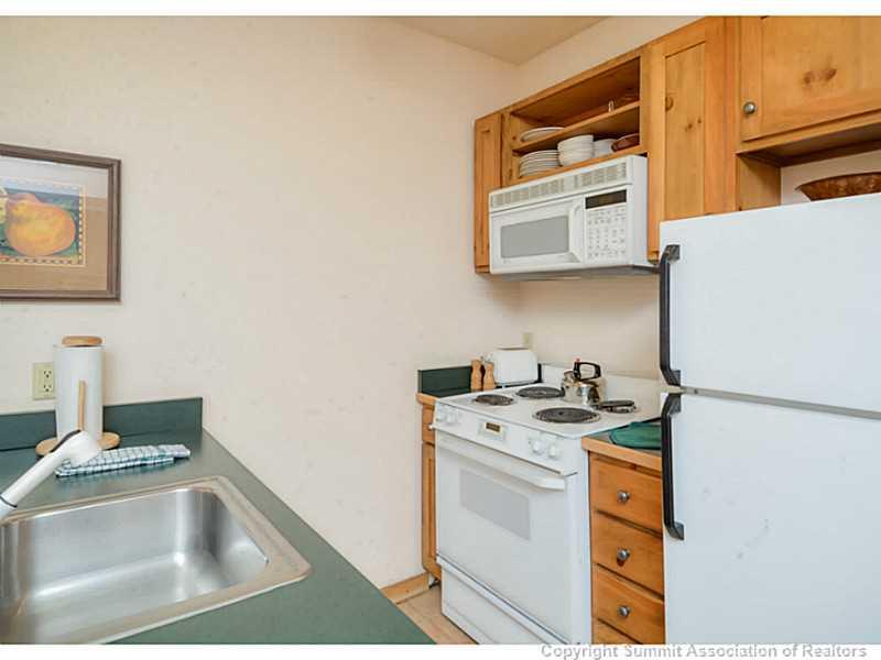 195 River Run Road, Unit 8045 Keystone, CO 80435 - Photo 8 of 15 a utility room with a sink a stove and a refrigerator