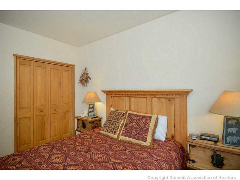 195 River Run Road, Unit 8045 Keystone, CO 80435 - Photo 10 of 15 a bedroom with a bed and a lamp on th table