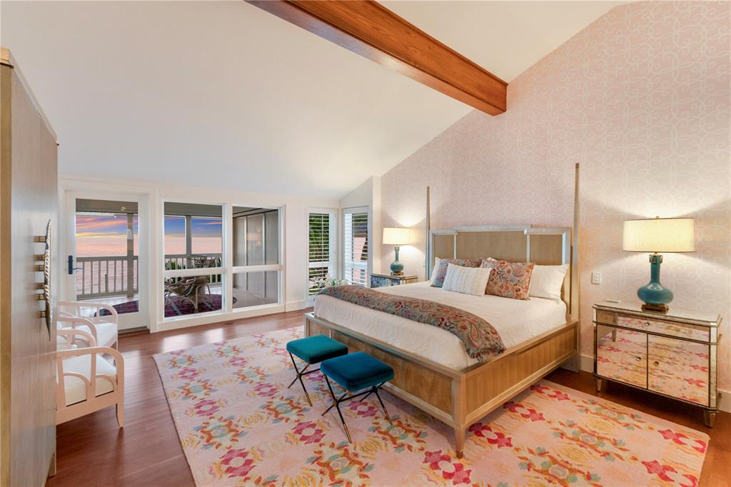 641 Boca Bay Drive Boca Grande, FL 33921 - Photo 25 of 74 a bedroom with a bed wooden floor and lamp