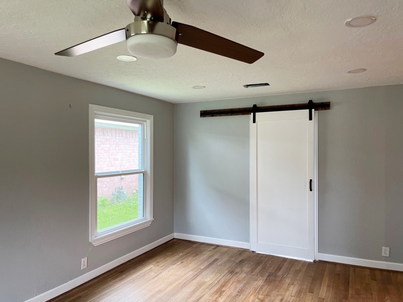 3522 Rosedale Street Houston, TX 77004 - Photo 18 of 22 an empty room with wooden floor and windows