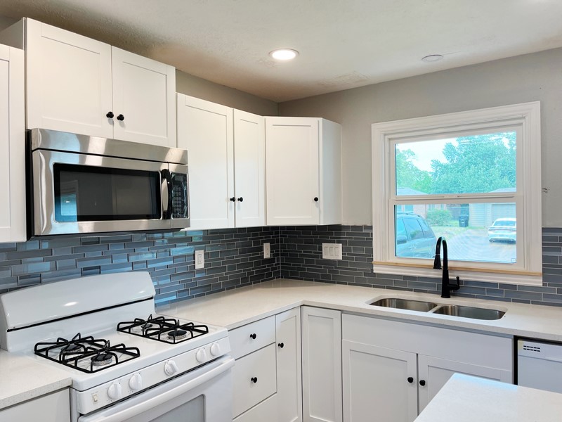 3522 Rosedale Street Houston, TX 77004 - Photo 2 of 22 a kitchen with cabinets appliances a sink and a window