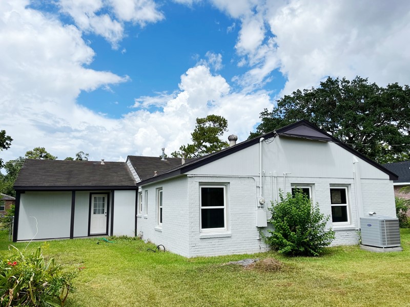 3522 Rosedale Street Houston, TX 77004 - Photo 21 of 22 a front view of house with yard and trees in the background