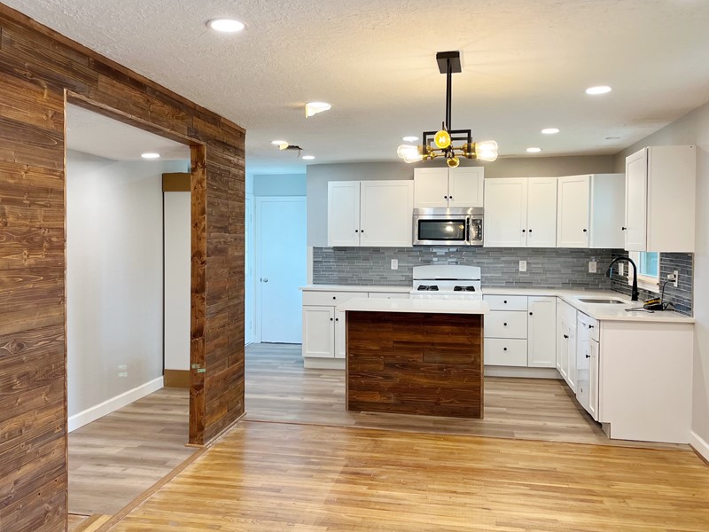 3522 Rosedale Street Houston, TX 77004 - Photo 5 of 22 a kitchen with kitchen island granite countertop stainless steel appliances a stove refrigerator and cabinets