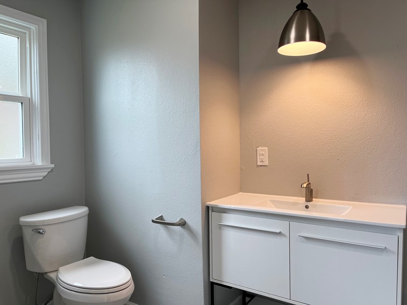 3522 Rosedale Street Houston, TX 77004 - Photo 10 of 22 a bathroom with a sink a toilet and vanity