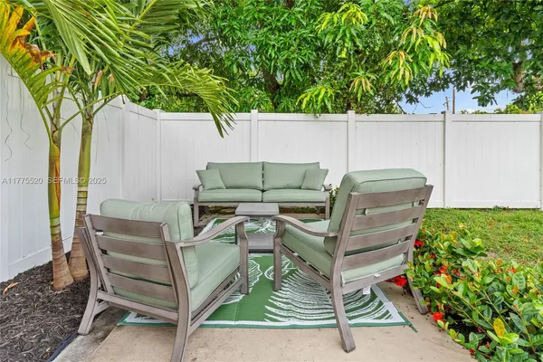 a view of a chairs and table in the patio