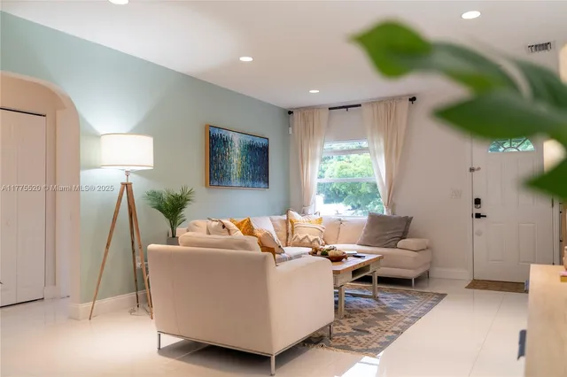 a living room with furniture and a large window