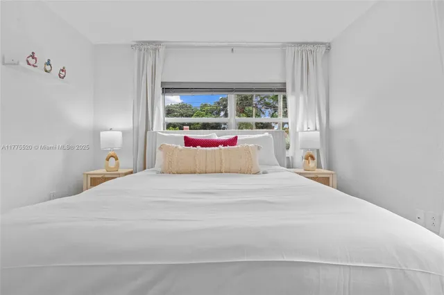 a bedroom with a large bed and a window