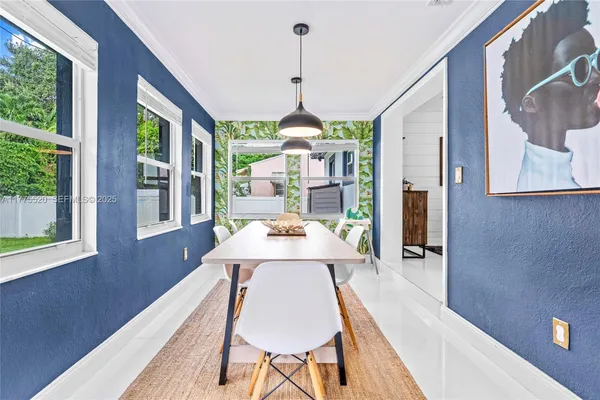 a dining room with wooden floor a chandelier a wooden table and chairs