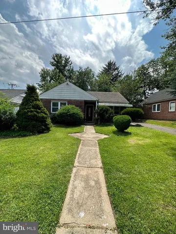 a view of a patio with table and chairs potted plants and large tree
