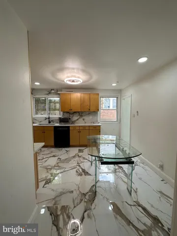 a view of kitchen with kitchen island microwave and view living room