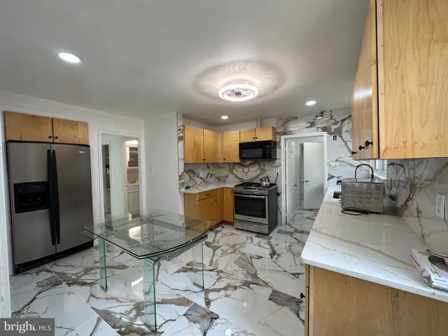 a kitchen with refrigerator and cabinets