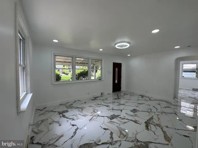 a view of a hallway to a bedroom with window
