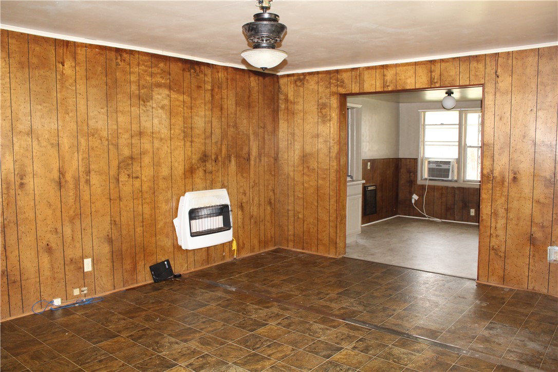400 Canaan Road Marshall, AR 72650 - Photo 11 of 18 The room features wood paneling, a ceiling fan with integrated lighting, and tiled flooring