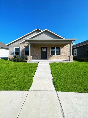 a front view of house with yard and green space