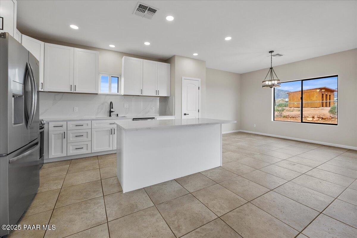 320 South Hoss Road Dewey, AZ 86327 - Photo 11 of 42 a kitchen with stainless steel appliances granite countertop a stove a sink and a refrigerator
