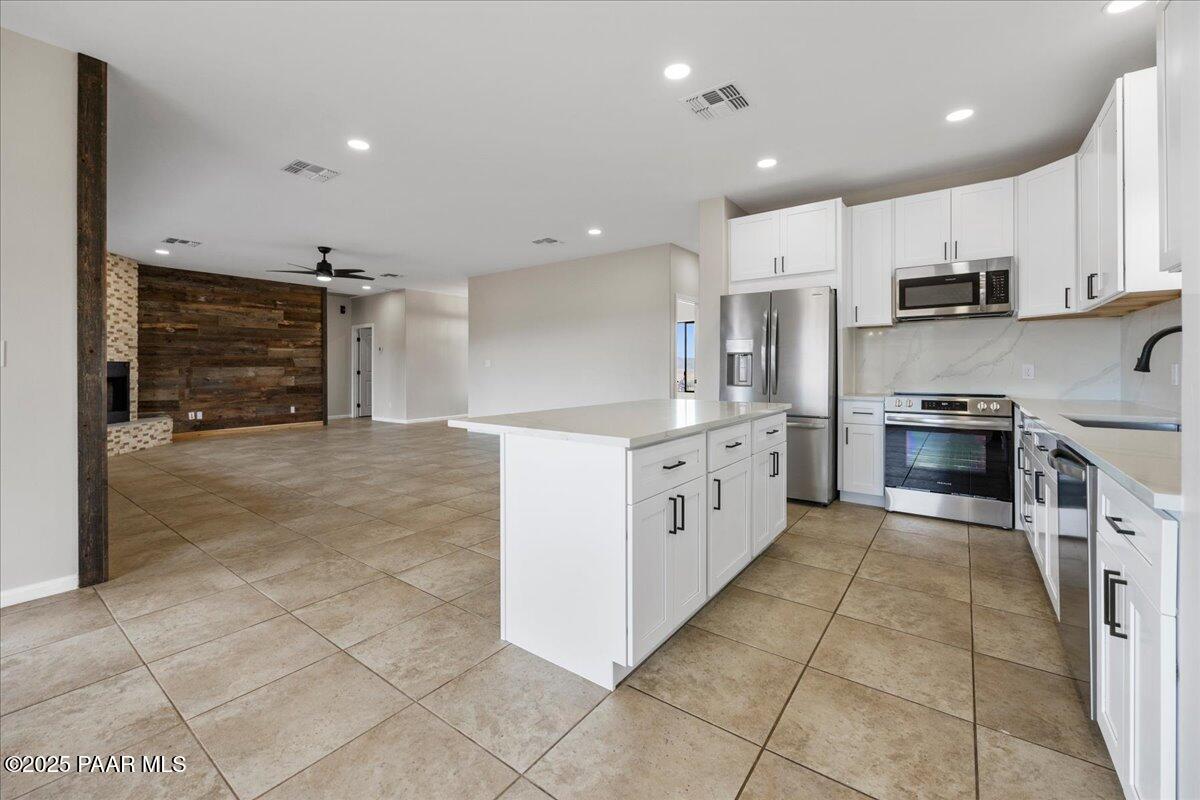 320 South Hoss Road Dewey, AZ 86327 - Photo 13 of 42 a large kitchen with stainless steel appliances granite countertop a large counter top and a stove top oven