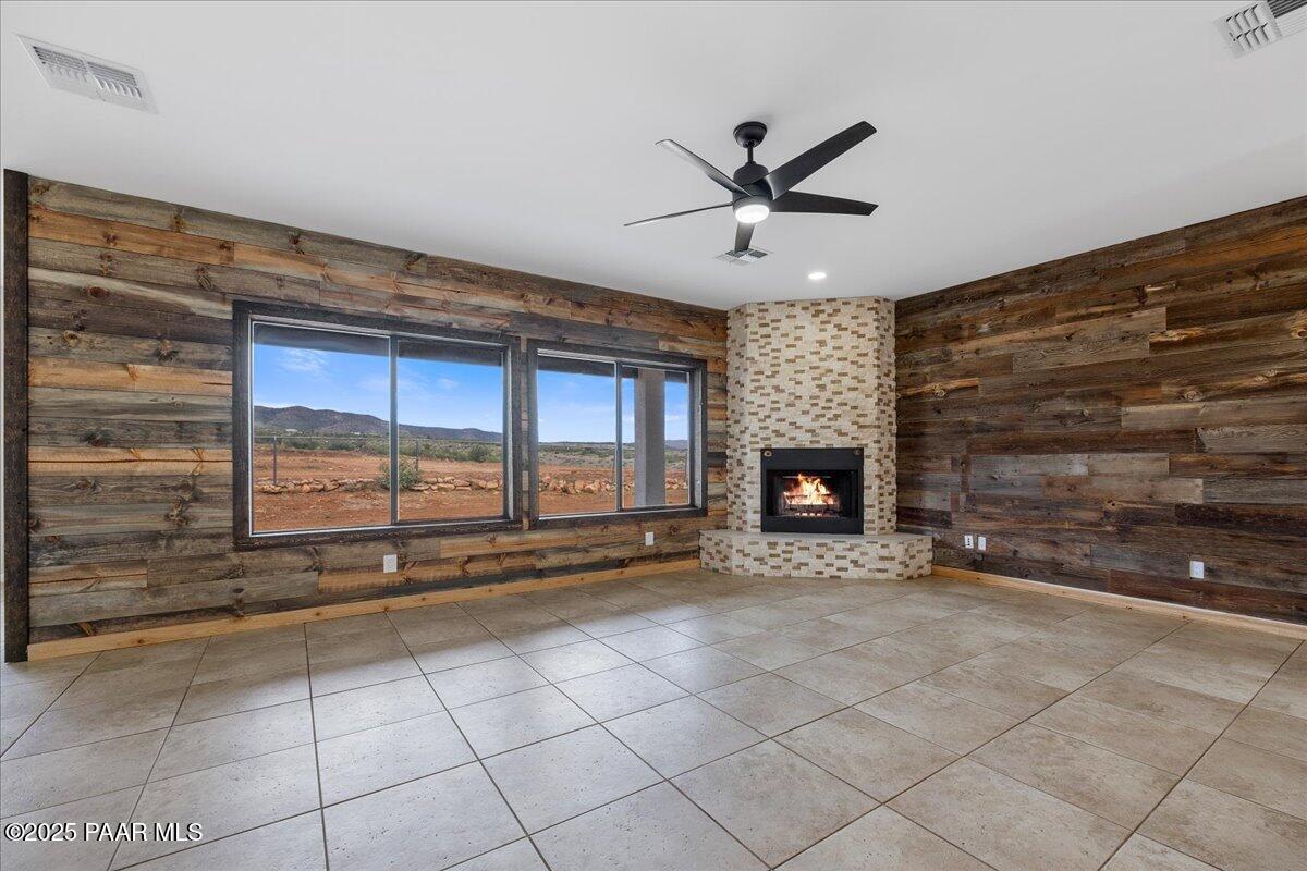 320 South Hoss Road Dewey, AZ 86327 - Photo 6 of 42 a view of an empty room with a fireplace and a window