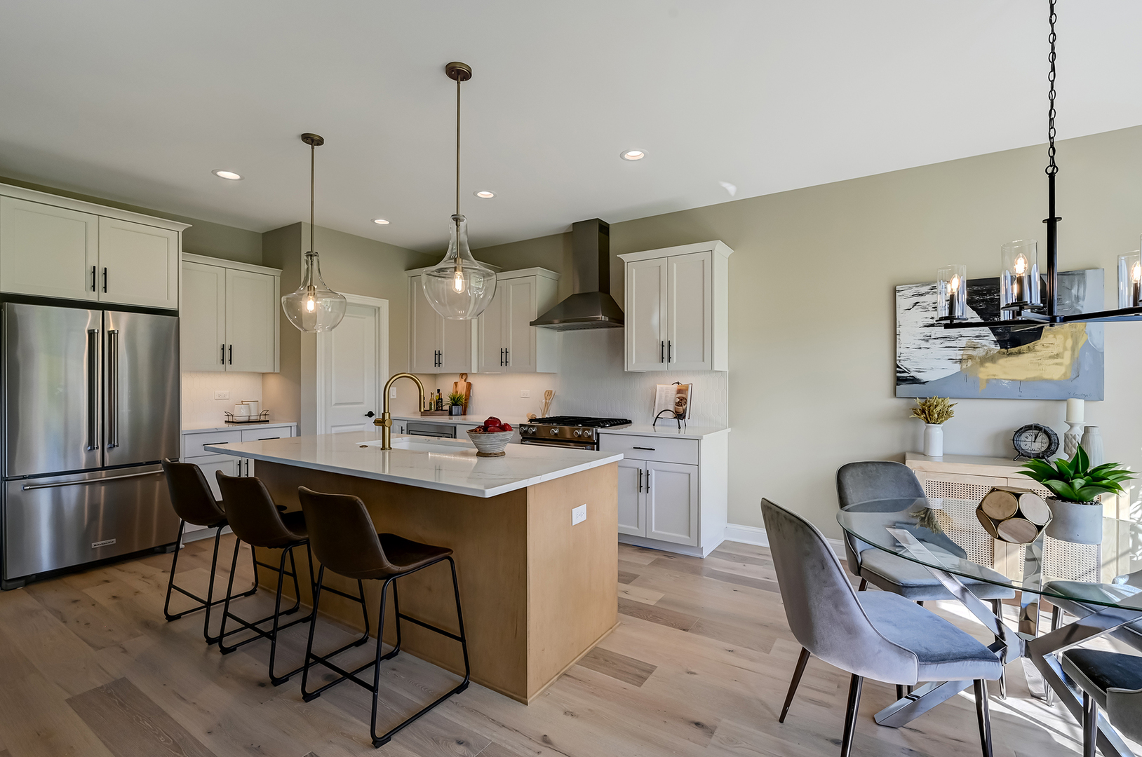 12215 Copper Ridge Drive, Unit 13 Lemont, IL 60439 - Photo 11 of 21 a kitchen with stainless steel appliances granite countertop a sink a stove a refrigerator and island with wooden floor