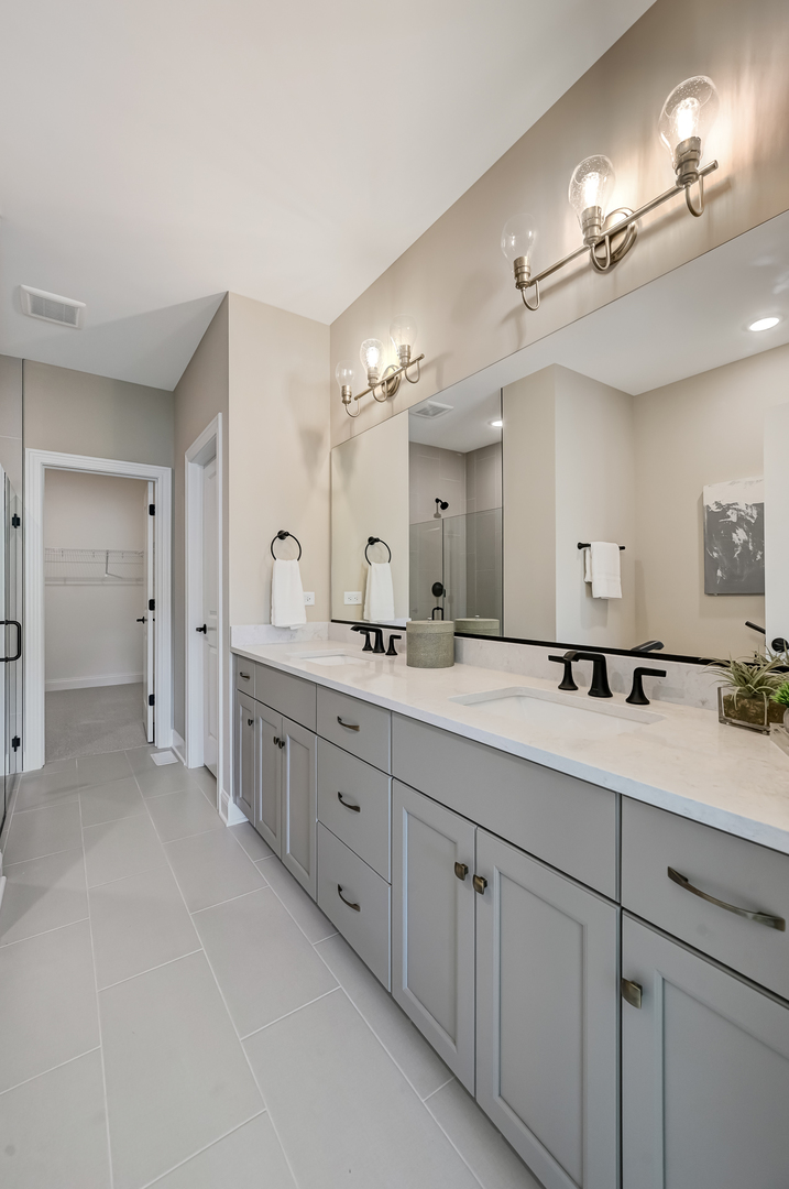 12215 Copper Ridge Drive, Unit 13 Lemont, IL 60439 - Photo 14 of 21 a spacious bathroom with a granite countertop sink a mirror and a shower