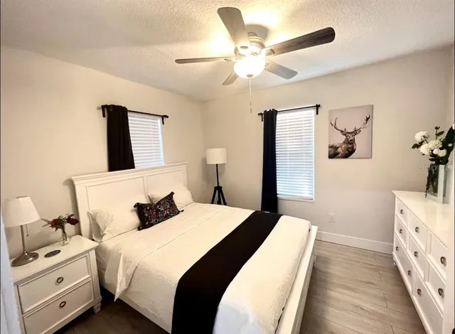 a spacious bedroom with a bed and a chandelier