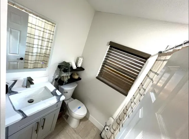 a backyard of a house with garden and trees