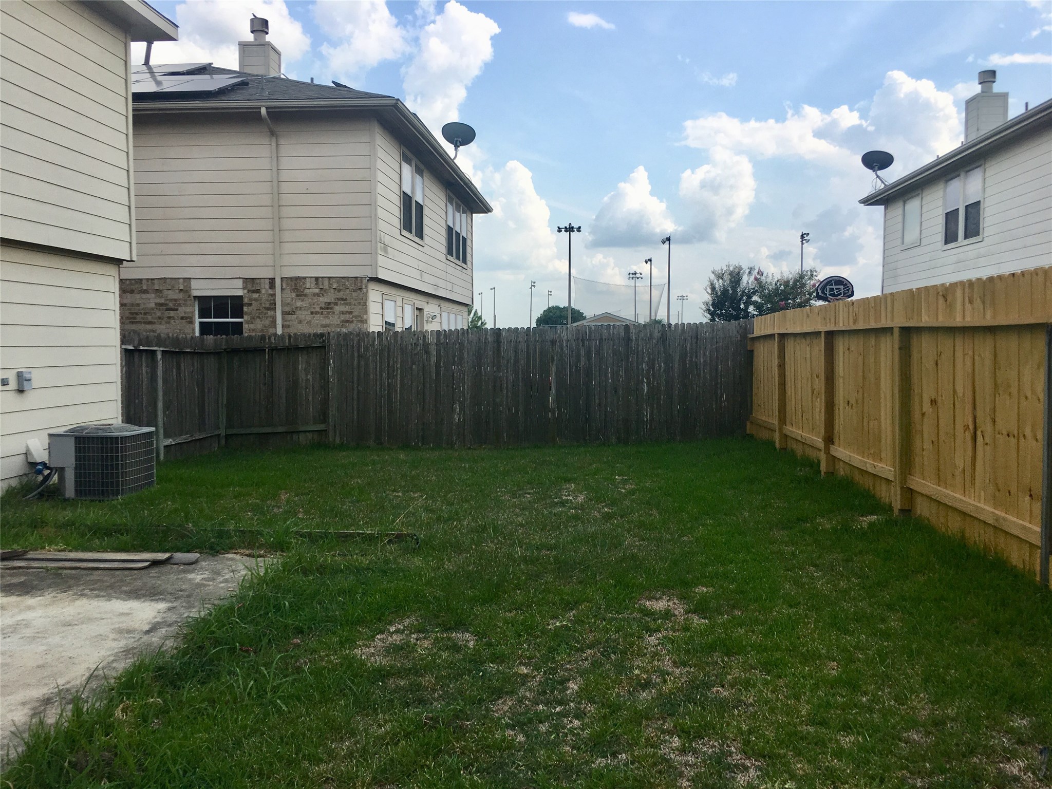 5707 Highbury Court Houston, TX 77084 - Photo 15 of 17 a view of a backyard with potted plants and wooden fence