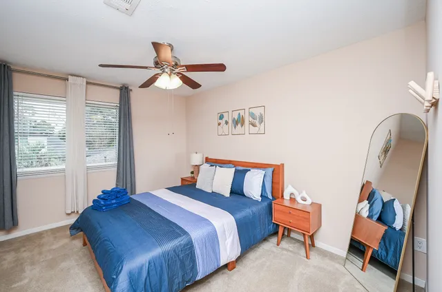 a bedroom with a bed and a painting on the wall