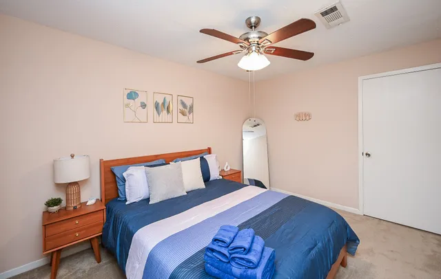 a bedroom with a bed and a chandelier