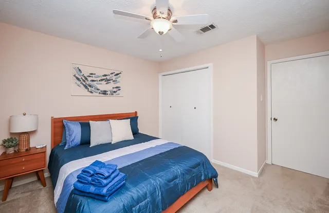a bedroom with bed and a chandelier